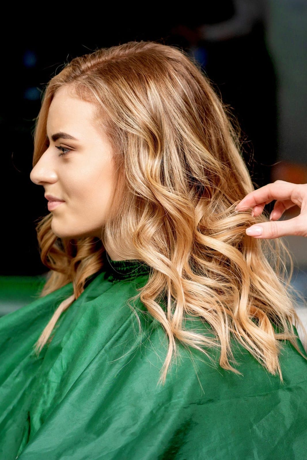 Schulterlanges blondes Haar mit weichen Wellen und hellen Strähnen nach dem Styling